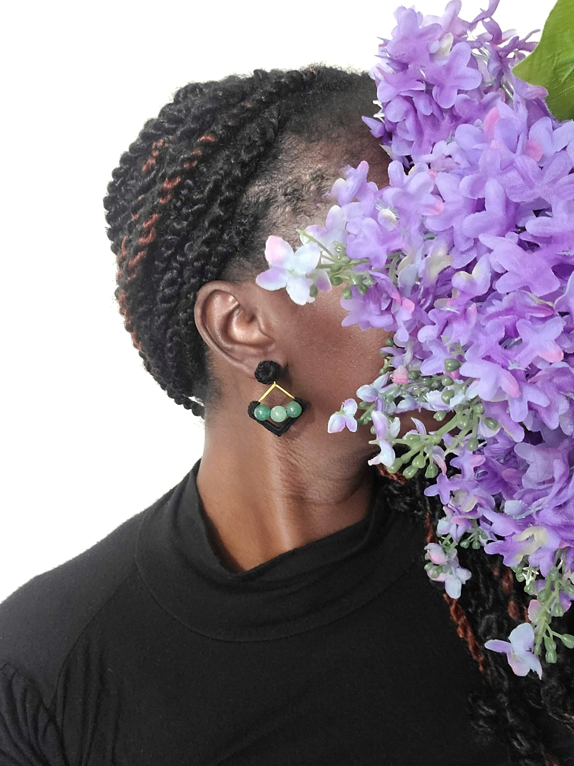 Model wearing green aventurine dangle earrings.