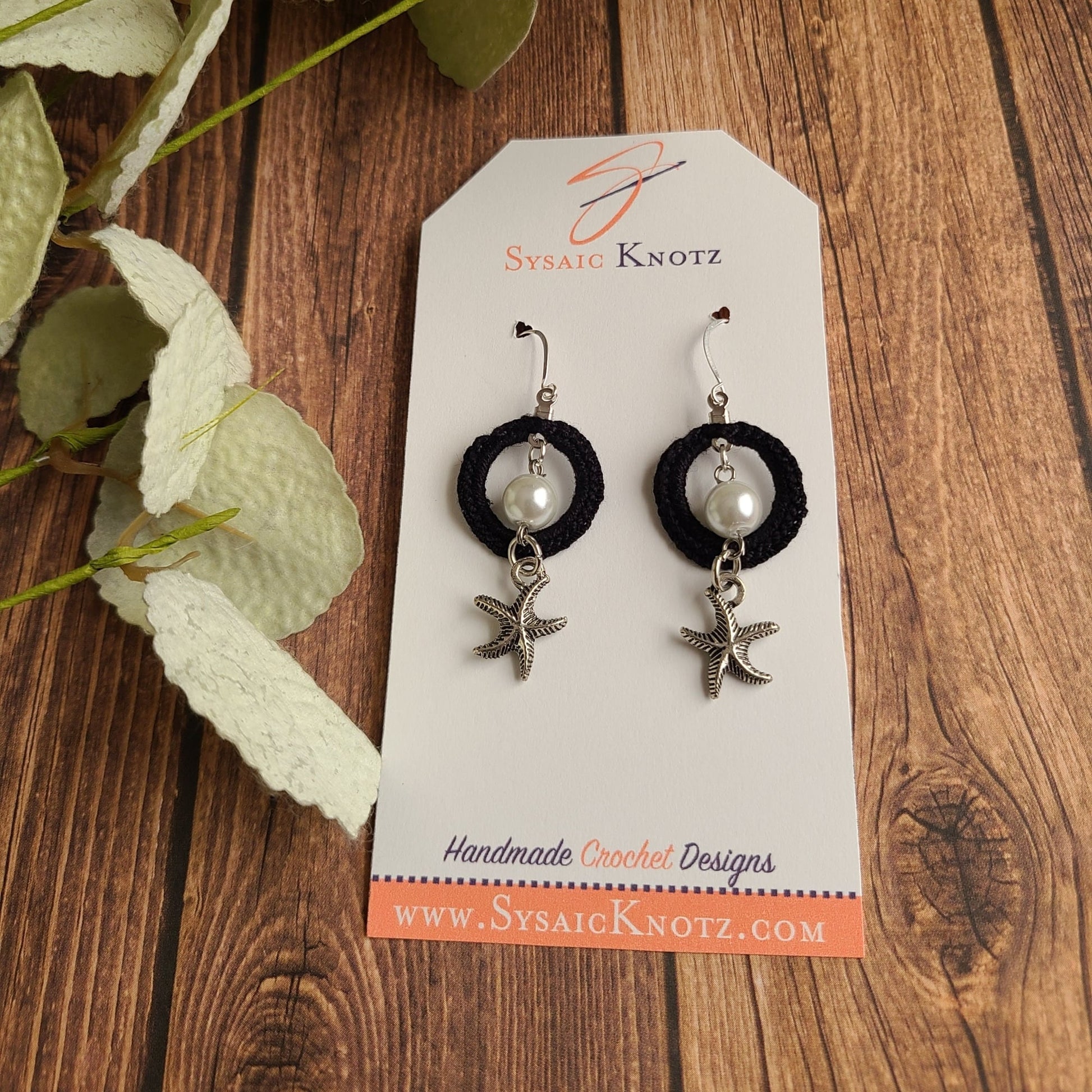 Pearl dangle earrings on wood
