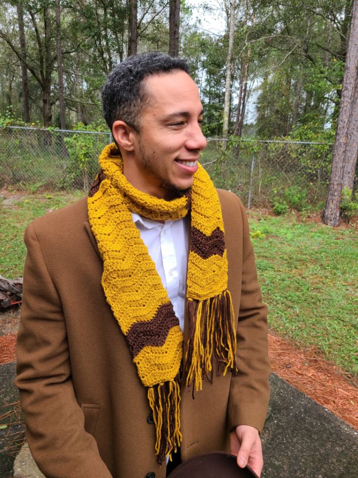 A man modeling two tone brown scarf.