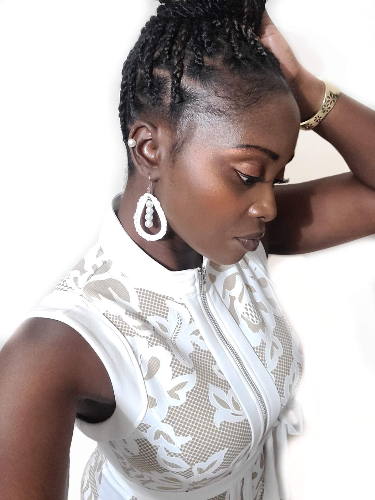Model wearing middle lined pearls in a tear drop crochet design to complete these handmade earrings.