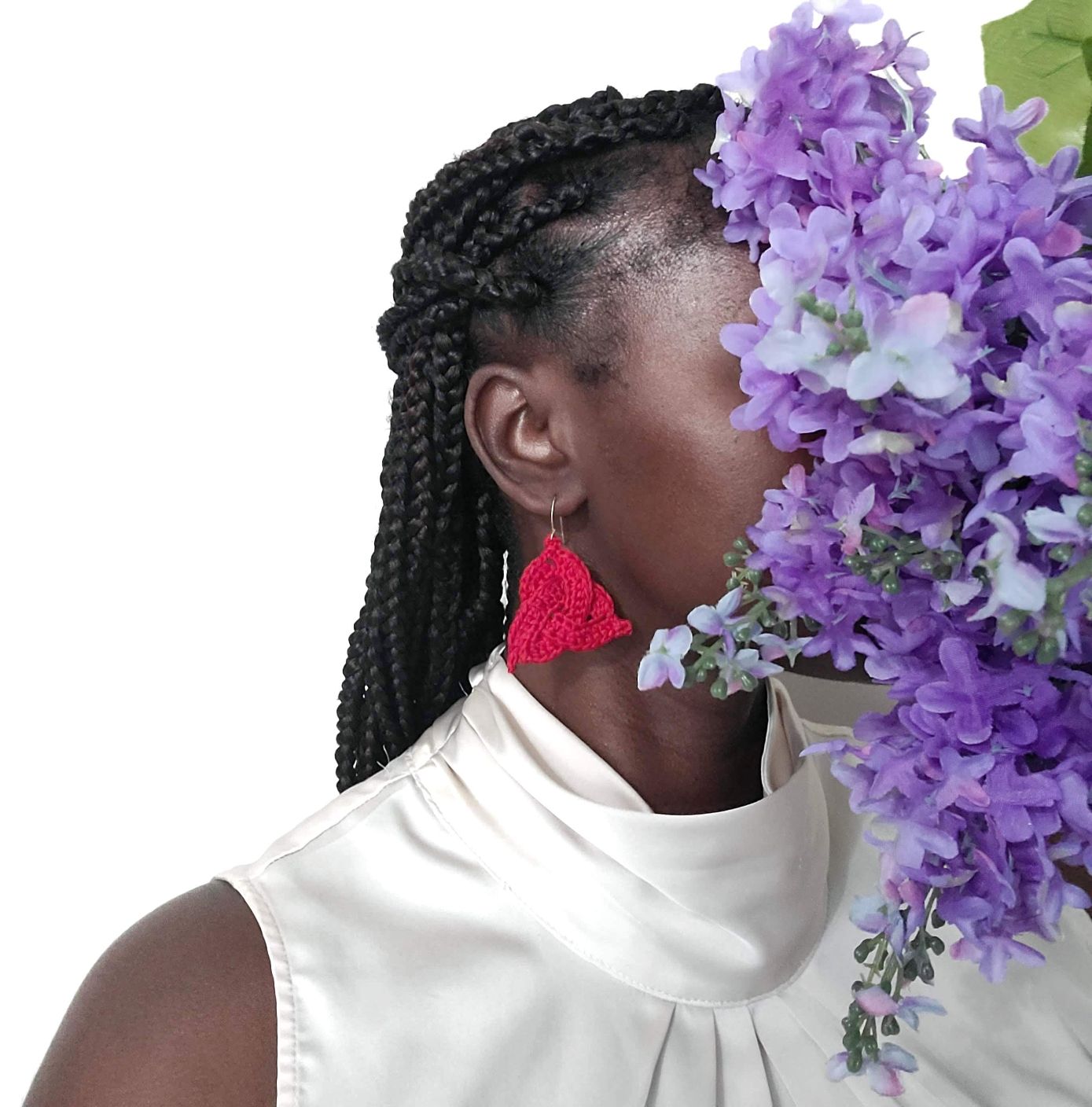 Model wearing red Celtic knot earrings.