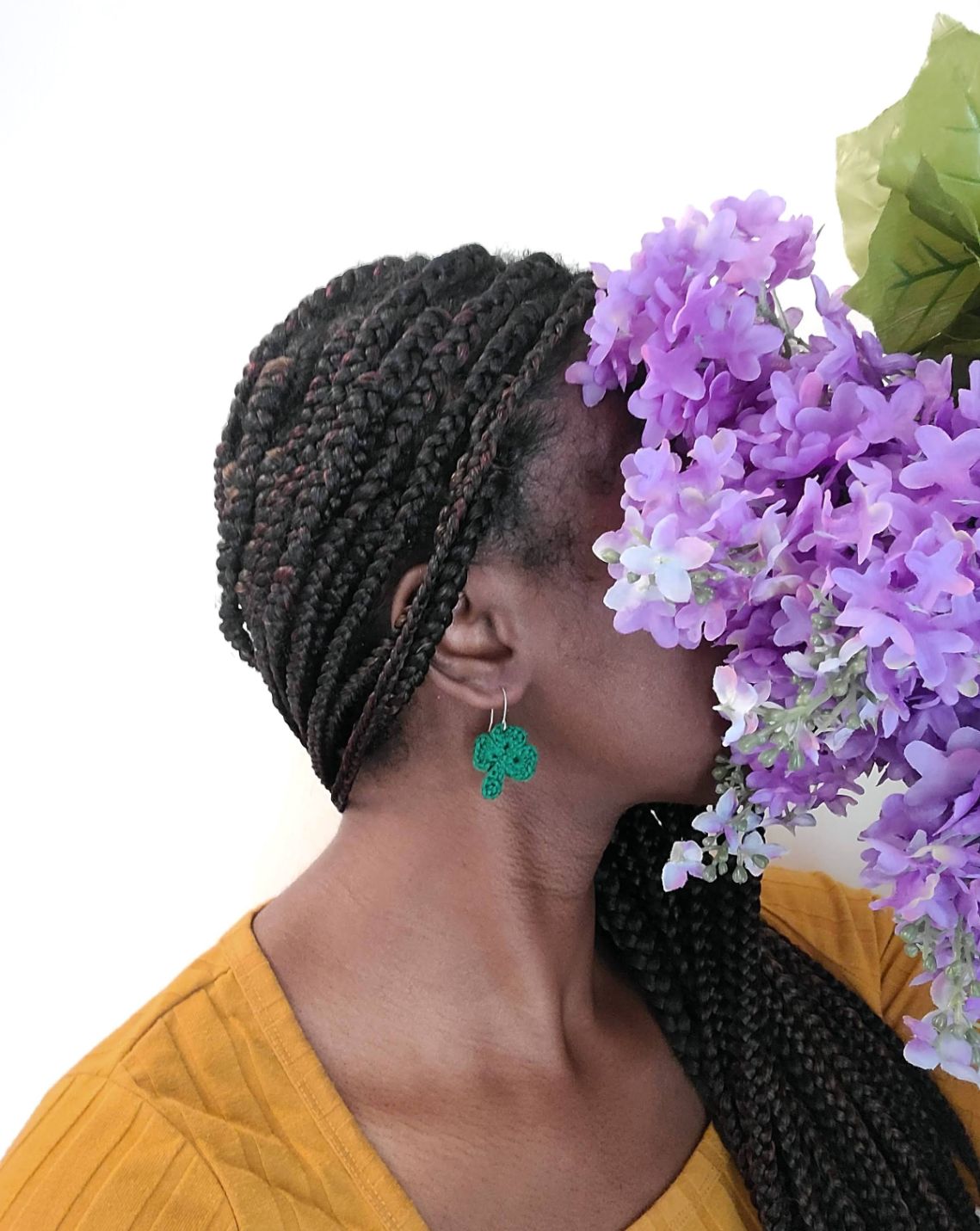 The model wearing 3 leaf clover earrings.