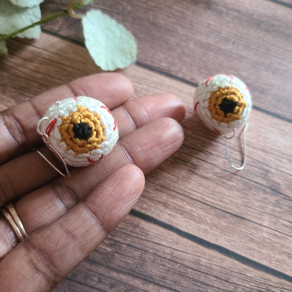 Gold eyeball earrings, that are Halloween earrings.