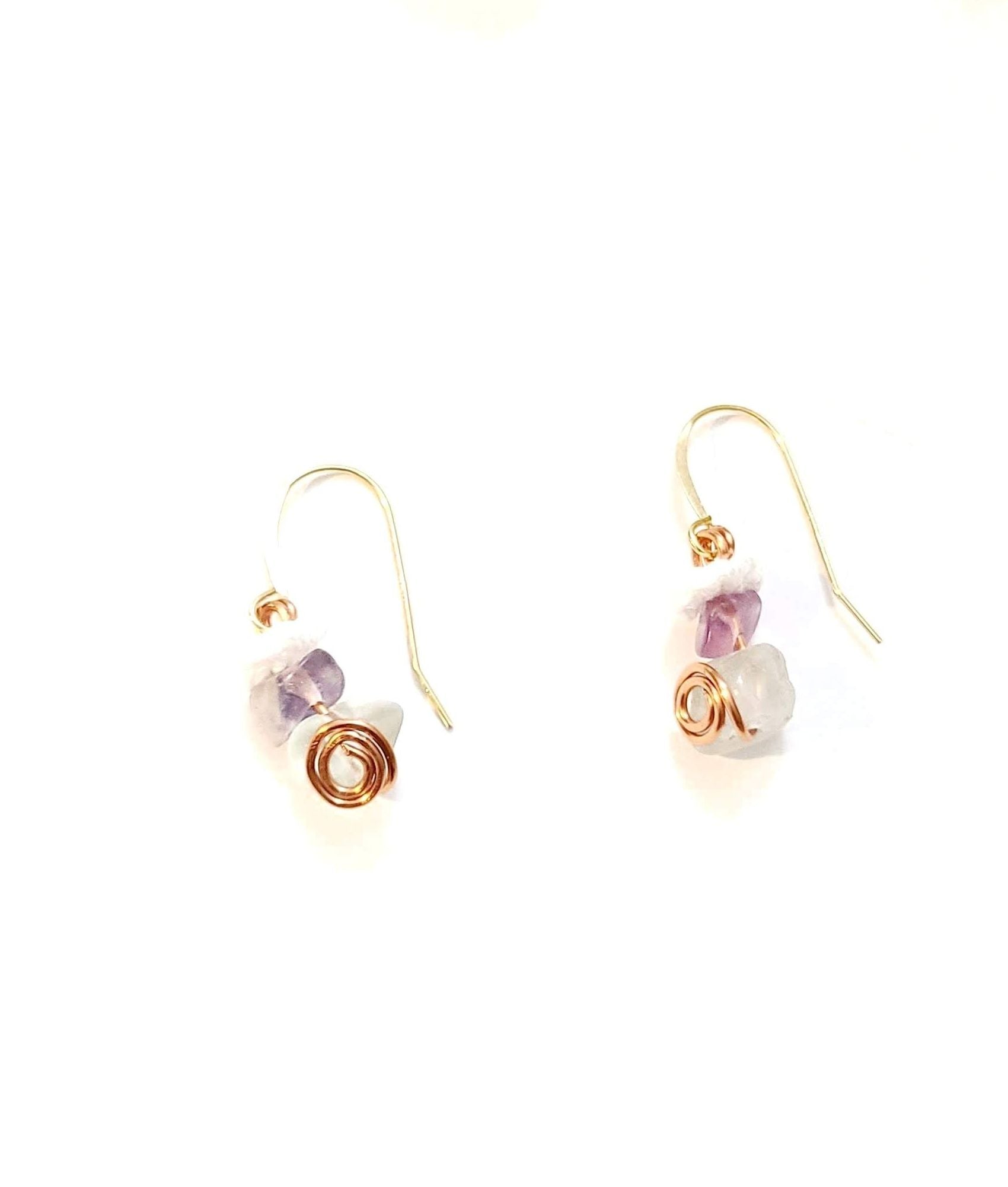 Close up on Fluorite dangle earrings with gold spiral.