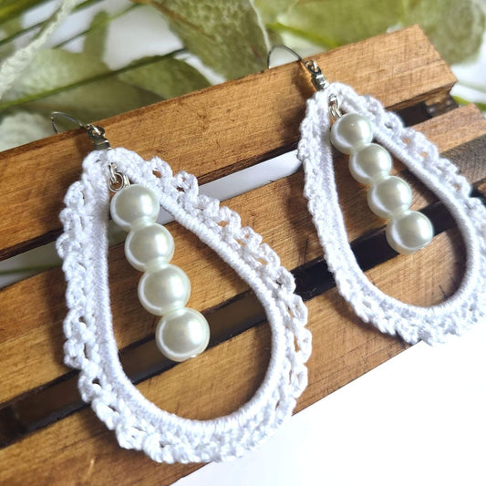 Pearl earrings in the middle of a tear drop crochet lace design.
