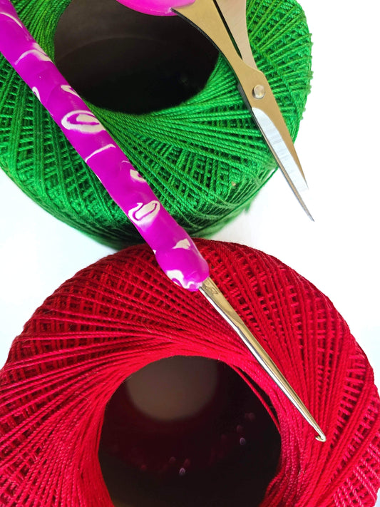 Thread yarn with a crochet hook and scissors.