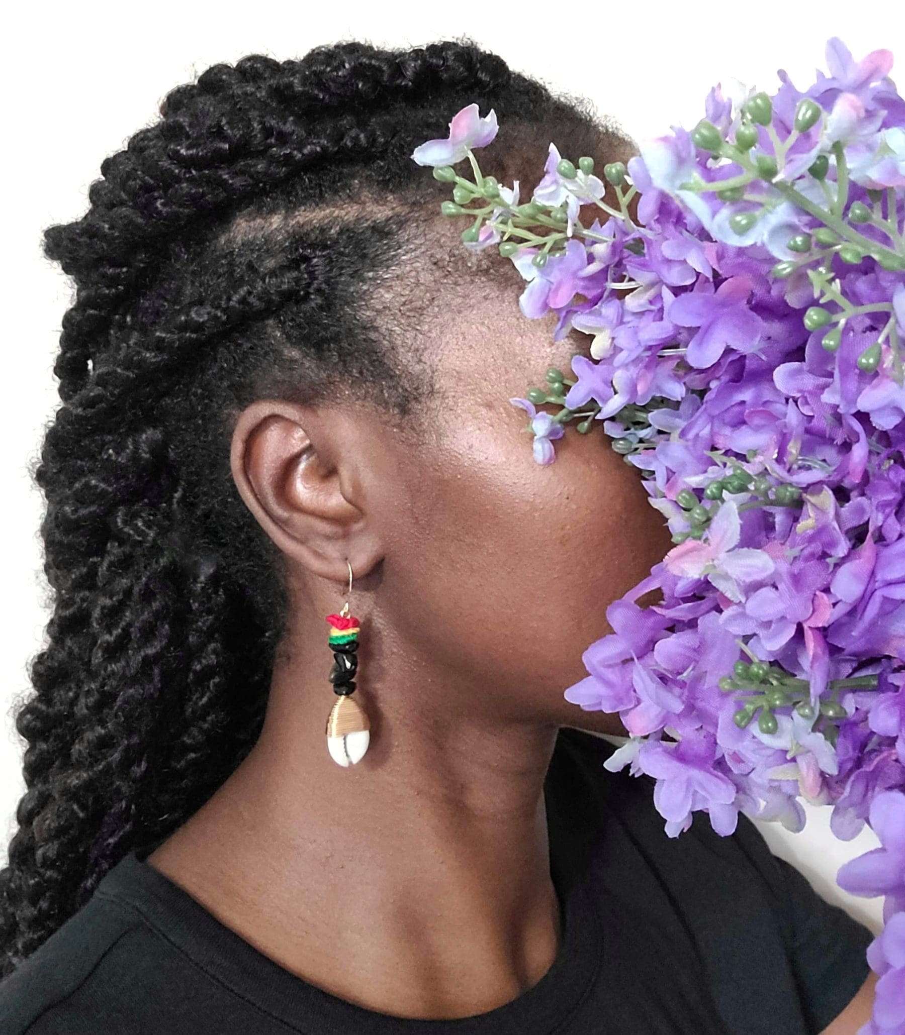 Model Wearing red, yellow, green cowrie shell earrings