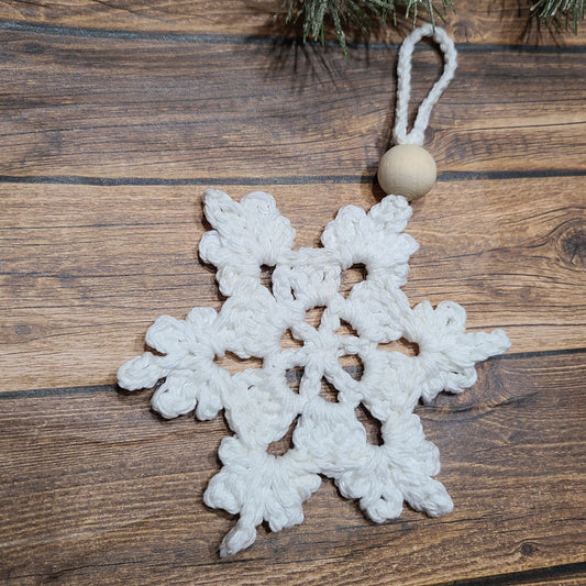 Snowflake Ornament on a wooden background.