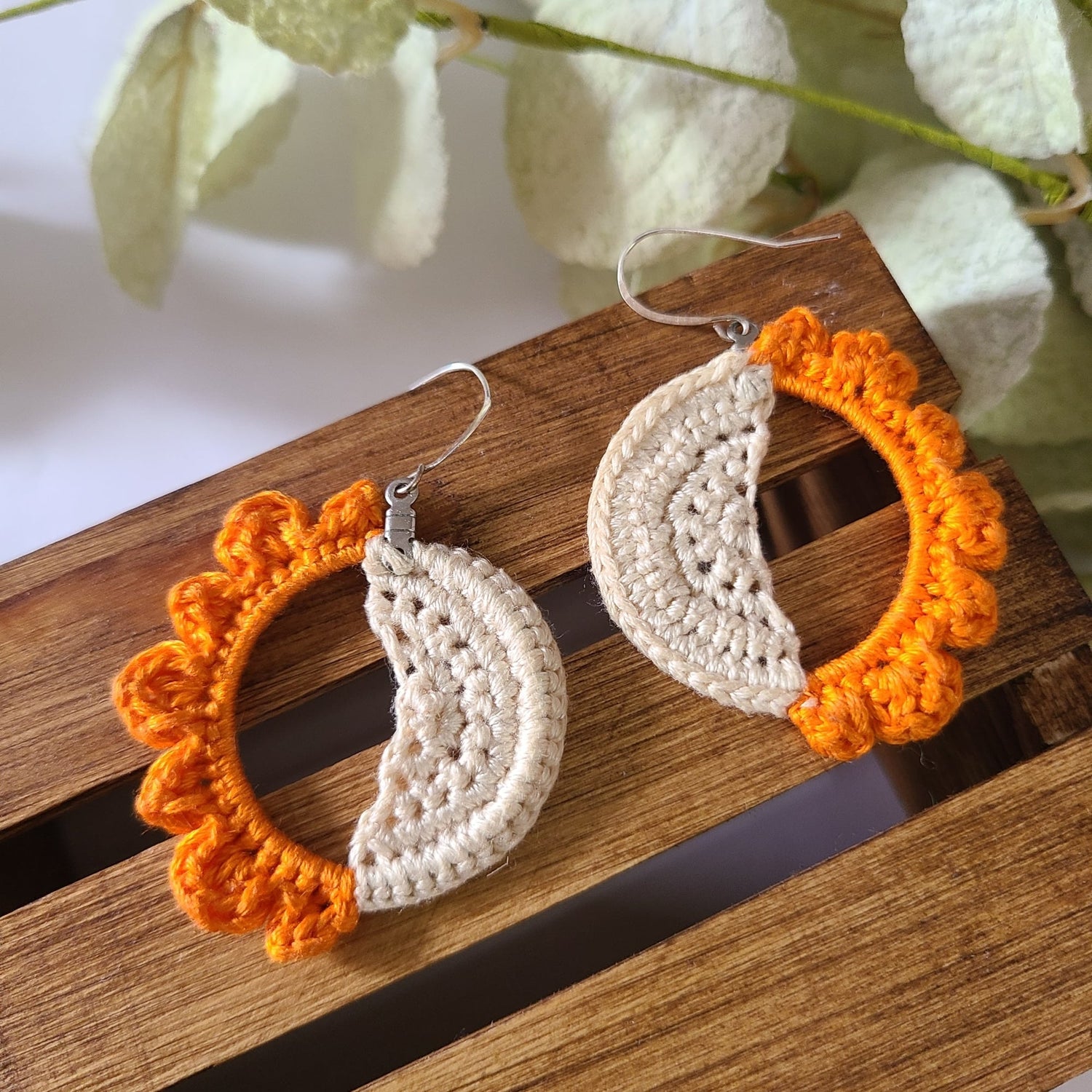 Sun and Moon earrings laid side by side.