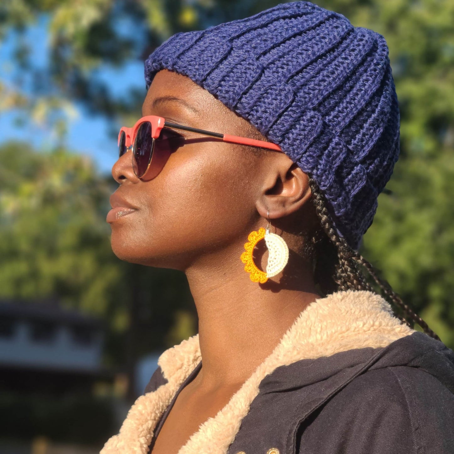 Model wearing sun and moon earrings.