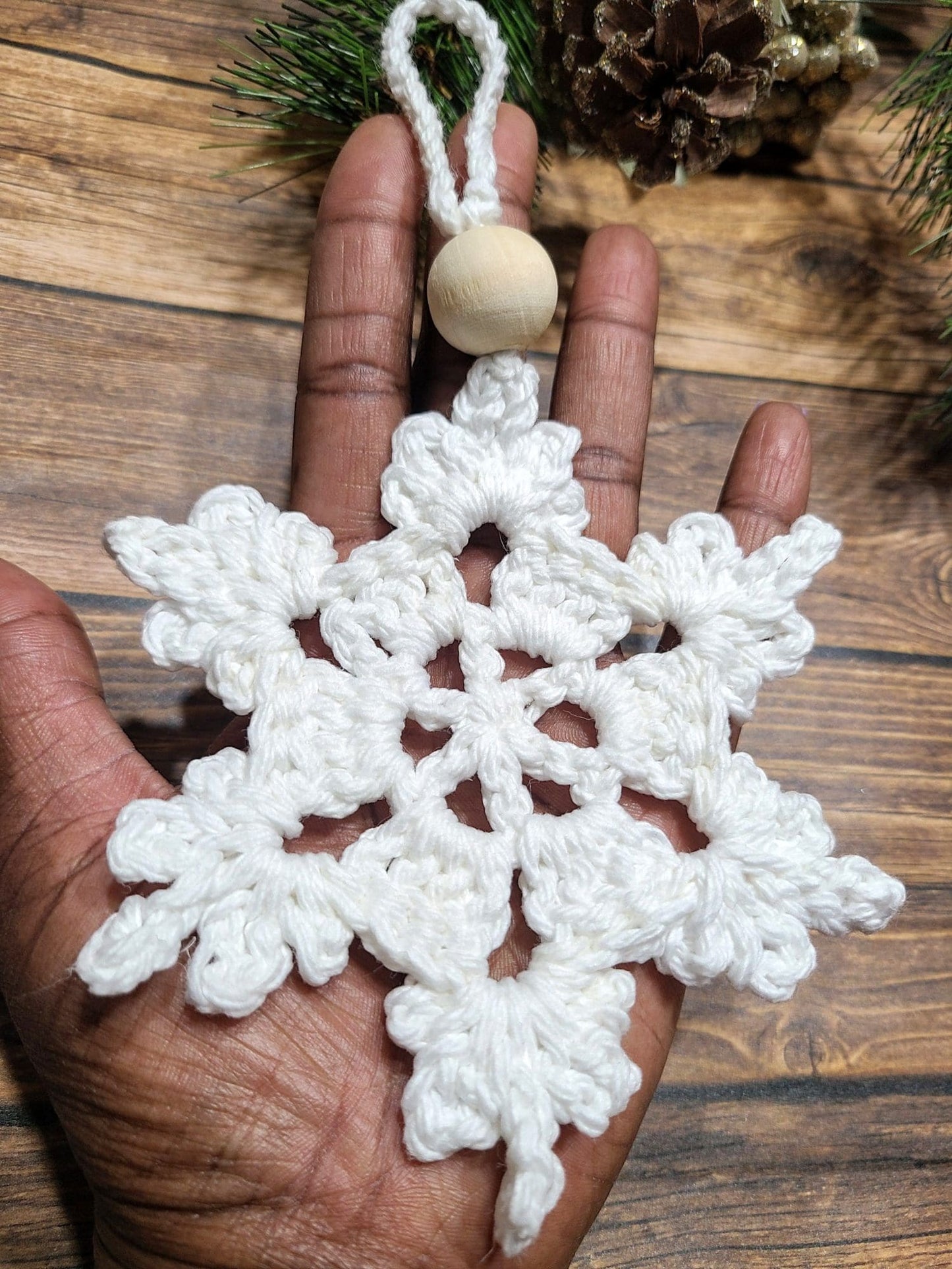 Large Snowflake Ornament in hand to show size.