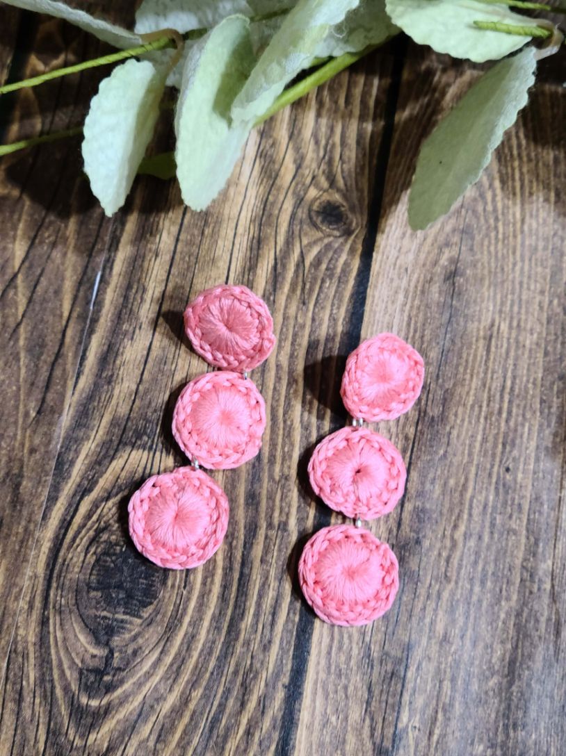 Triple circle dangle earrings in a soft pink