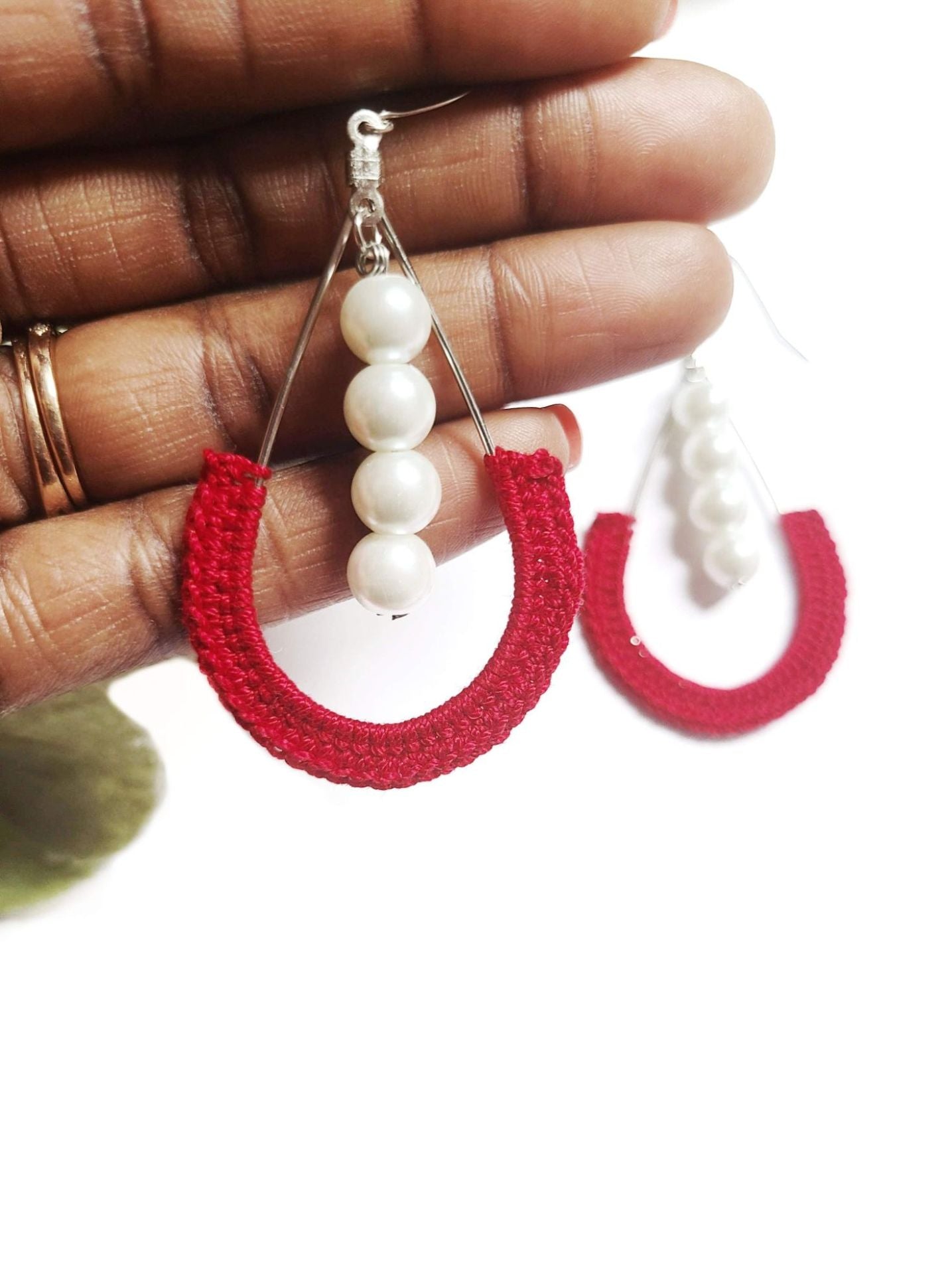 Red dangle pearl earrings.