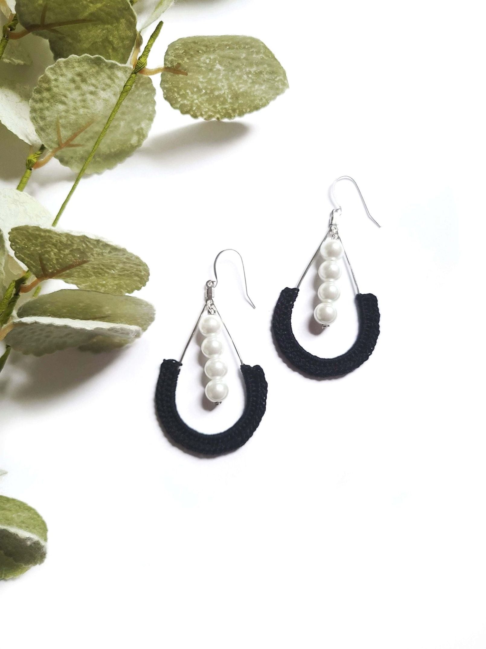 Black dangle pearl earrings.