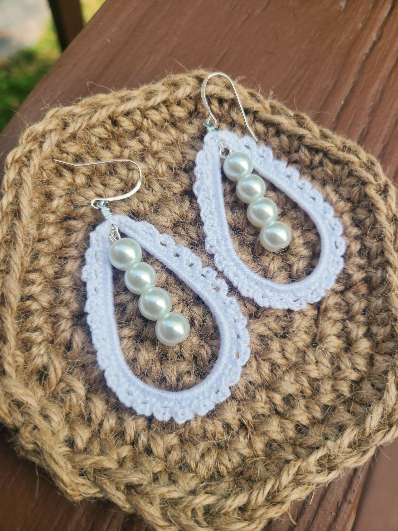 Tear drop earrings with a line of pearls in the middle.