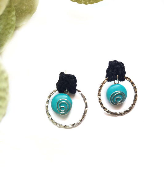 Black post earrings with turquoise spirals. 