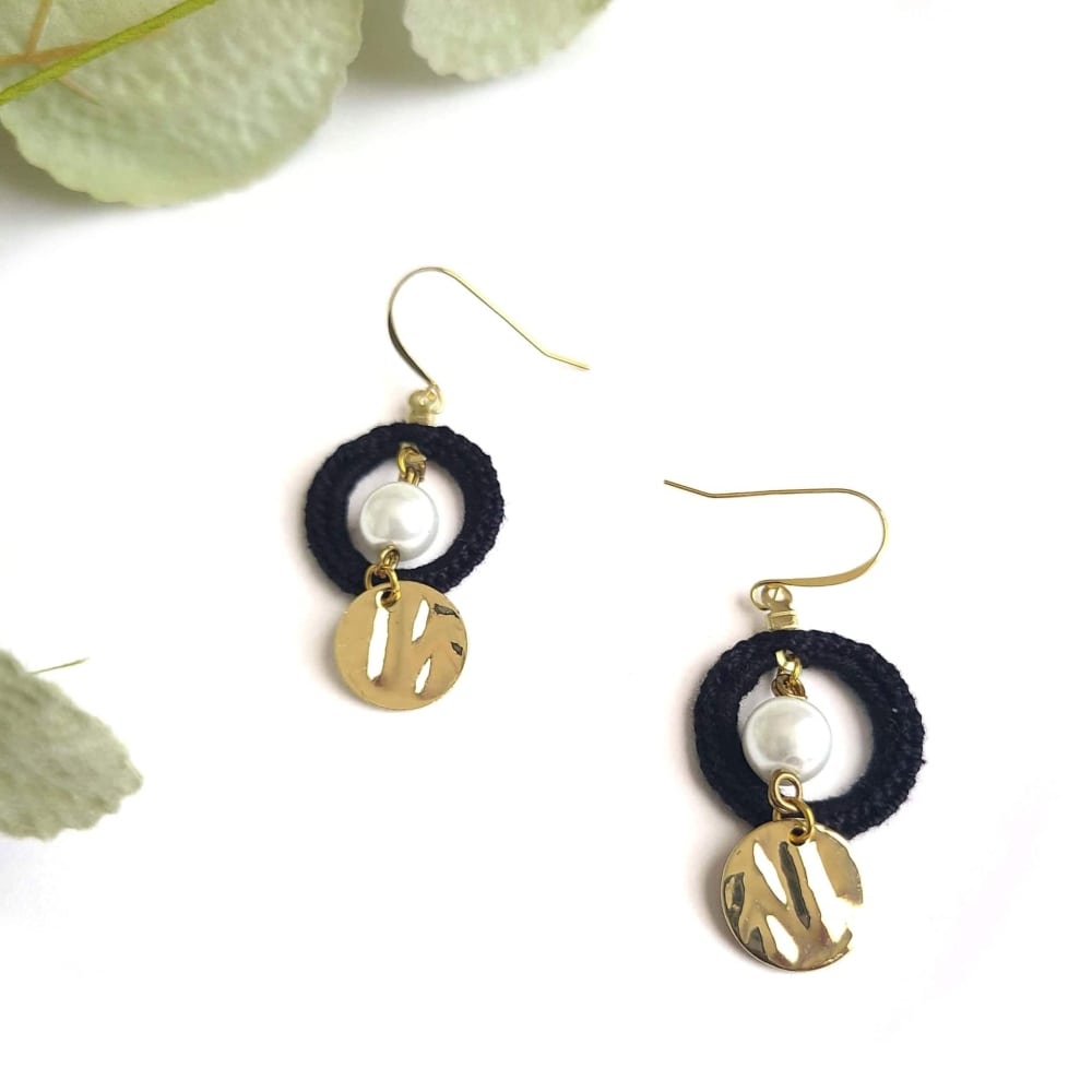 Dangle pearl earrings with gold.
