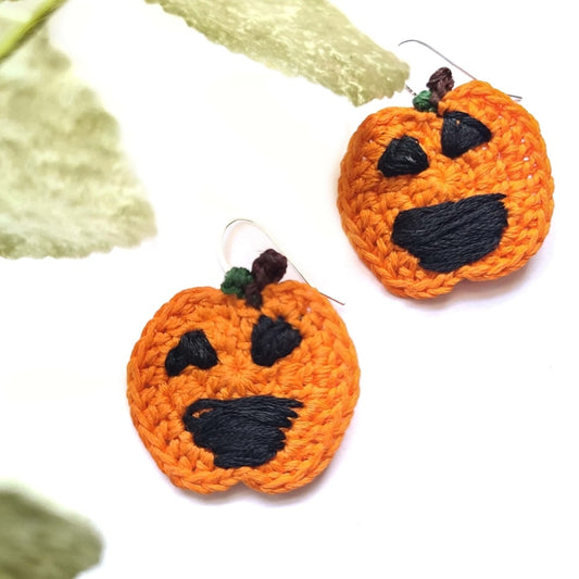 Jack O Lantern earrings with handmade smiles  and black triangle shaped eyes for Halloween earrings.