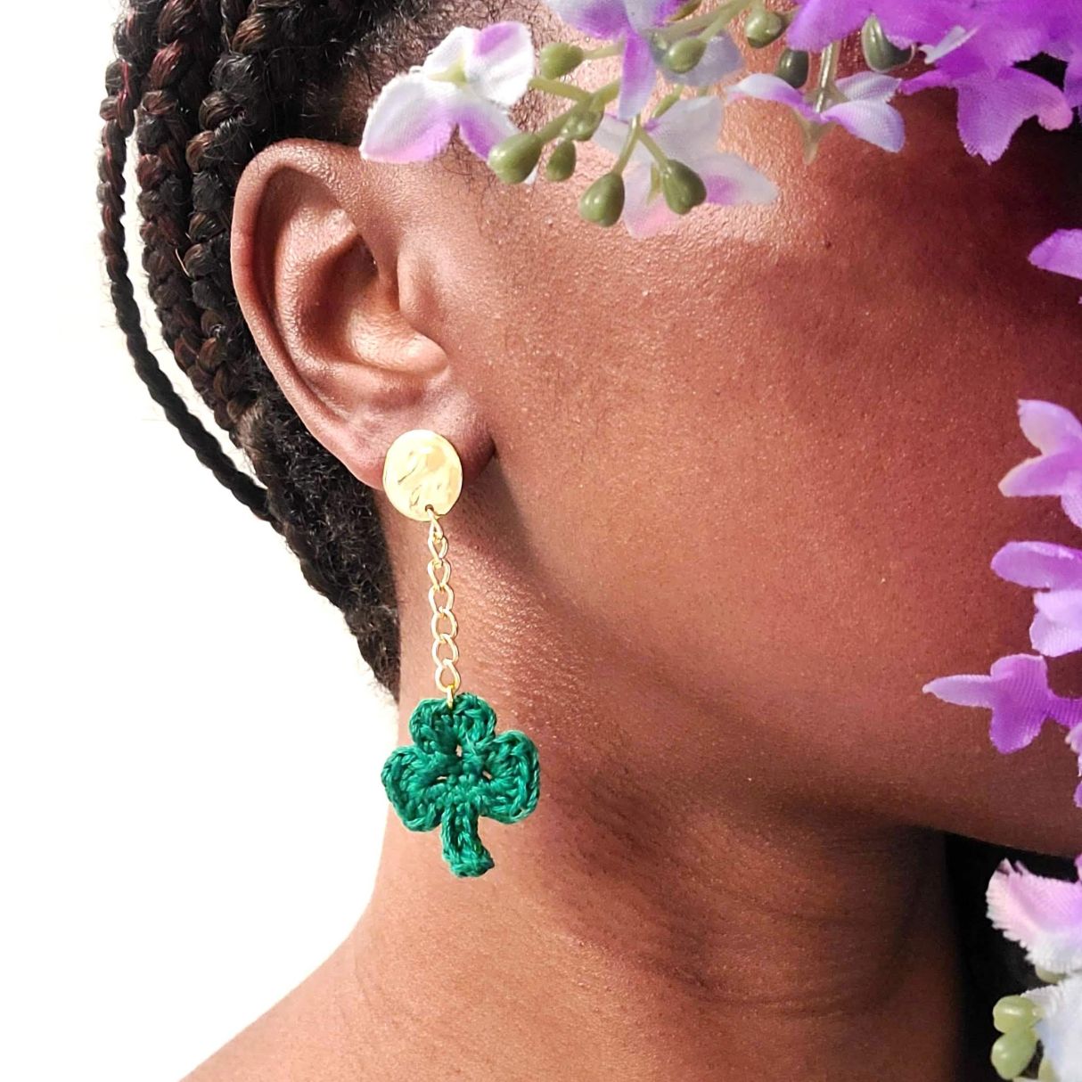 Model wearing a pair of shamrock dangle earrings.